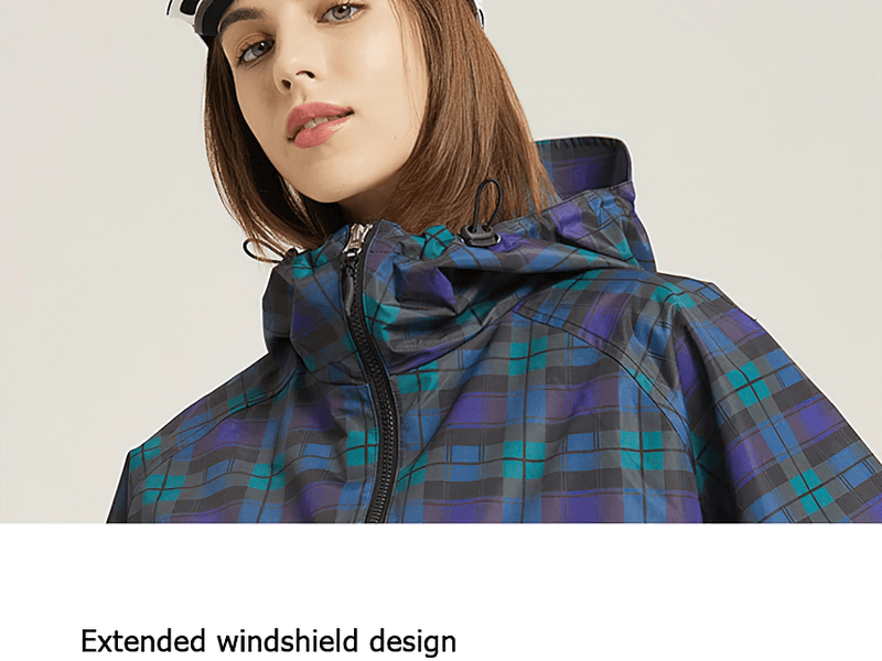 Model wearing blue plaid two-way zip skiing jacket with hood, showcasing its extended windshield design for extra protection in winter.